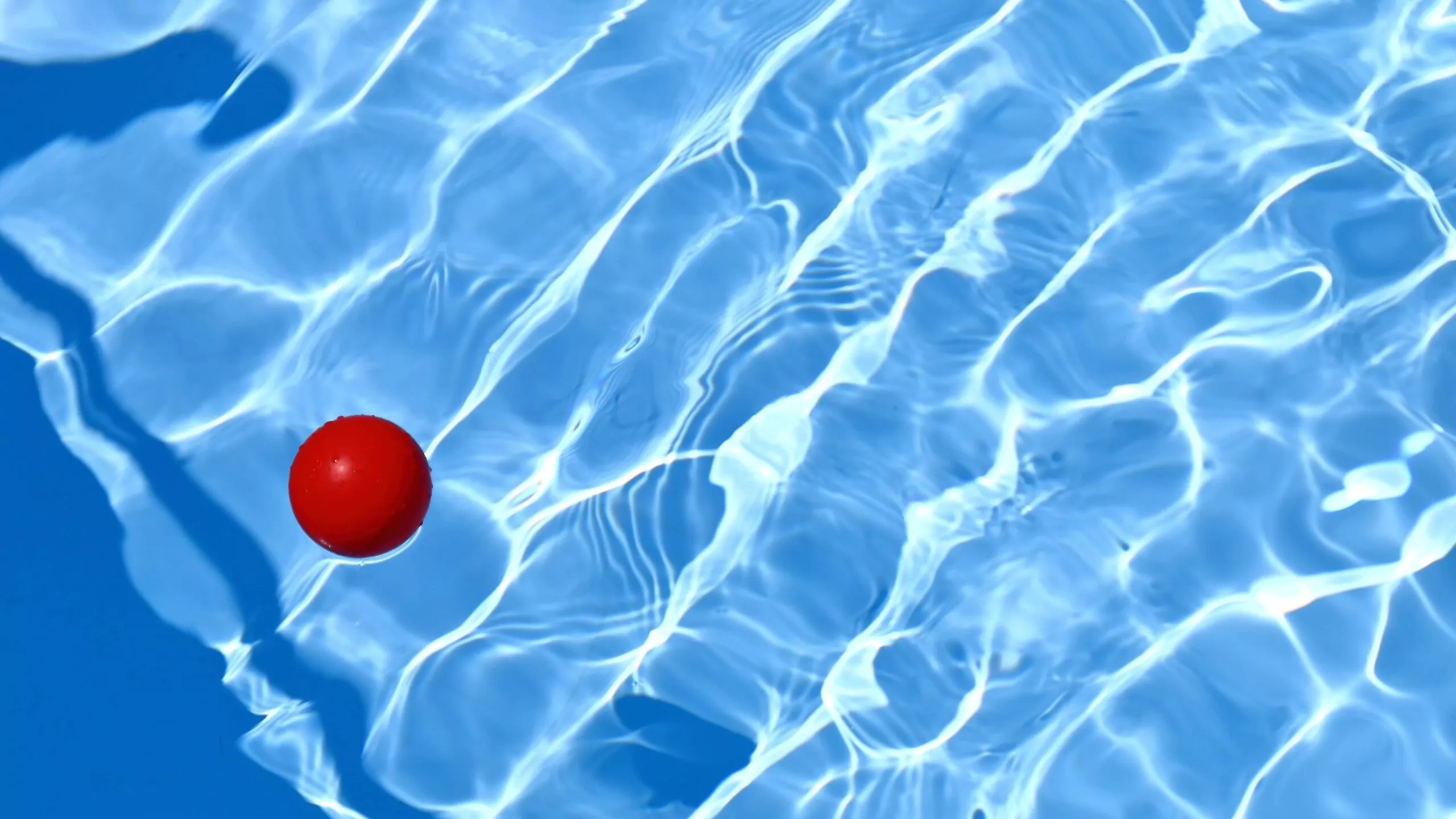 Red ball in a blue swimming pool